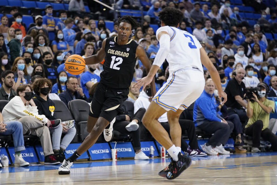 UCLA guard Johnny Juzang (3) defends against Colorado forward Jabari Walker (12) during the first half of an NCAA college basketball game in Los Angeles, Wednesday, Dec. 1, 2021. (AP Photo/Ashley Landis)