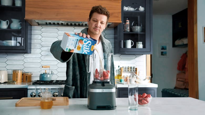 Jeremy Renner pouring Silk into blender