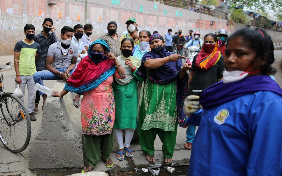 Women stranded in Nizamuddin plead to be let through a makeshift barricade to their homes in Sarai Kale Khan - Cheena Kapoor