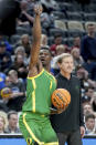 Oregon's N'Faly Dante (1) celebrates in front of head coach Dana Altman, right, after defeating South Carolina in a first-round college basketball game in the NCAA Tournament in Pittsburgh, Thursday, March 21, 2024. (AP Photo/Gene J. Puskar)