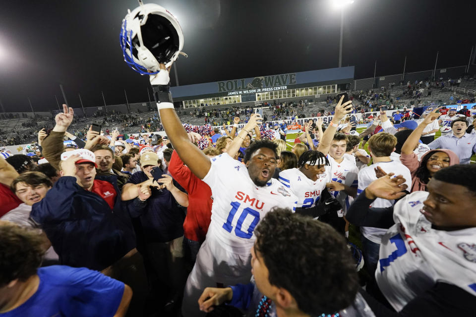 SMU defensive end David Abiara (10) celebrates on the field after defeating Tulane in the American Athletic Conference championship NCAA college football game, Saturday, Dec. 2, 2023 in New Orleans. SMU won 26-14. (AP Photo/Gerald Herbert)