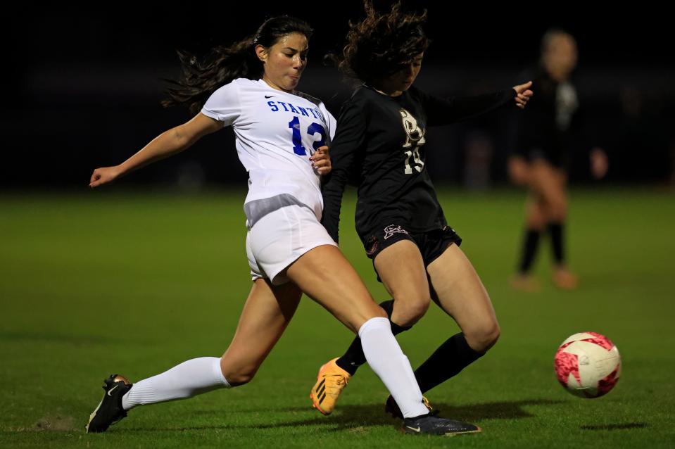 Stanton's Emma Griner (13) vies for the ball with Atlantic Coast's Laura Barroso (19) during a Gateway Conference semifinal.