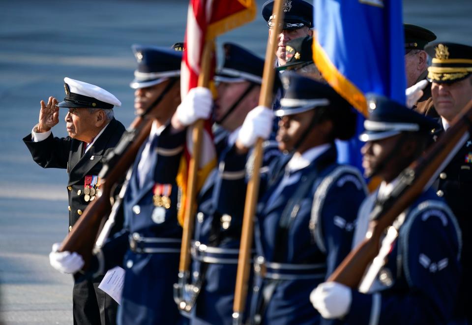 In 2021, United States Navy veteran and Congressional Gold Medal recipient Remigio Cabacar, then-94, salutes during a Veterans Day memorial event at the World War II Memorial.