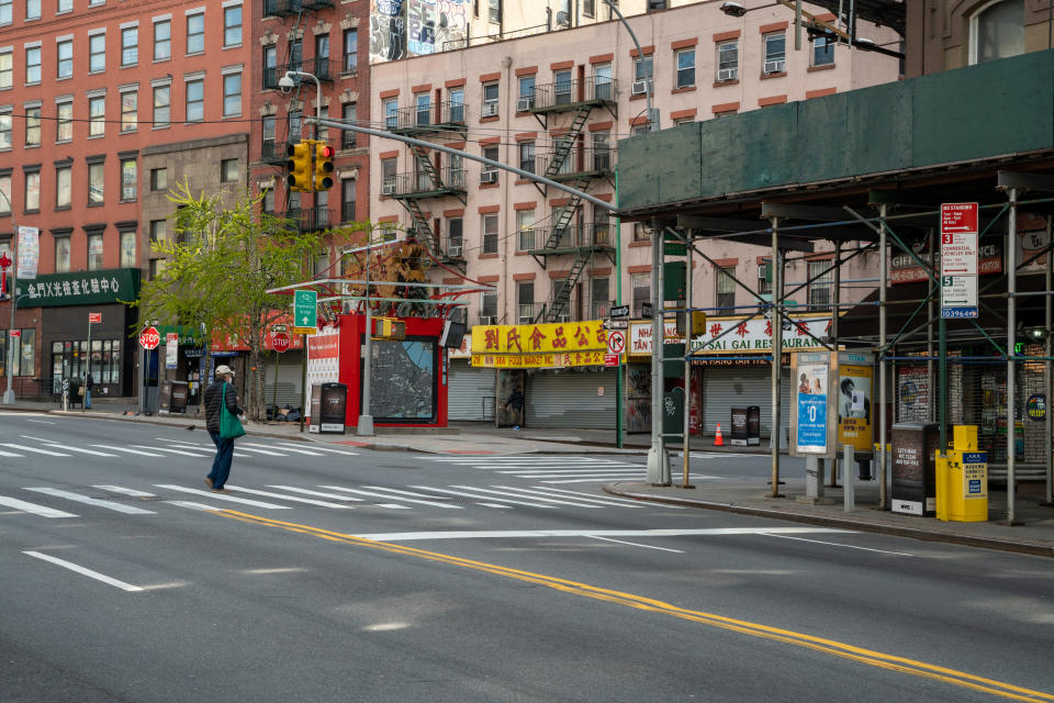 NEW YORK, NY - APRIL 16: A person walks in a desolate Chinatown shopping area on April 16, 2020, in New York City. New York State Governor Andrew Cuomo announced during his daily COVID-19 briefing that the 