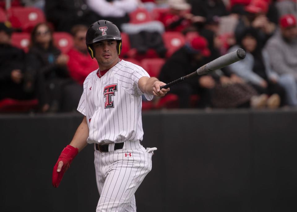 Texas Tech's infielder Austin Green (20) points to Texas Tech's catcher Kevin Bazzell (4) after scoring a run from his base hit against BYU in game three of their Big 12 baseball series, Saturday, March 23, 2024, at Rip Griffin Park.