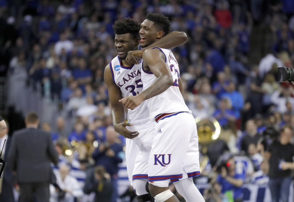 Kansas’ Udoka Azubuike, left, and Silvio De Sousa celebrate after defeating Duke 85-81 in overtime of a regional final game in the NCAA men’s college basketball tournament Sunday, March 25, 2018, in Omaha, Neb. (AP Photo/Charlie Neibergall)