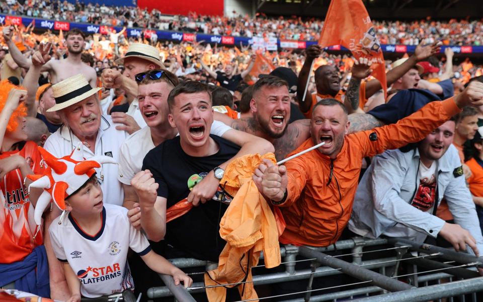 Luton Town's fans celebrate after Luton win the penalty shoot-out in the English Championship play-off final football match between Coventry City and Luton Town at Wembley Stadium - AFP/Adrian Dennis