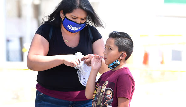 A child takes a COVID-19 test at a walk-in Coronavirus test site in Los Angeles, California.