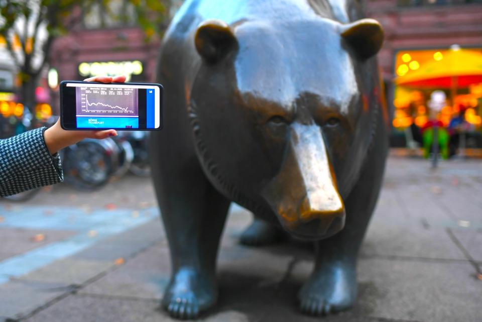 FRANKFURT, Oct. 28, 2020 -- Photo taken on Oct. 28, 2020 shows the DAX index on a mobile phone screen in front of the Bull and Bear sculptures outside the Frankfurt Stock Exchange in Frankfurt, Germany. German shares lost on Wednesday, with the benchmark DAX index down 503.06 points, or 4.17 percent, to close at 11,560.51 points. (Photo by Lu Yang/Xinhua via Getty) (Xinhua/Lu Yang via Getty Images)