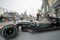 Mercedes driver Lewis Hamilton of Britain pulls out of his garage during the first practice session at the Marina Bay City Circuit ahead of the Singapore Formula One Grand Prix in Singapore, Friday, Sept. 20, 2019. (AP Photo/Vincent Thian)