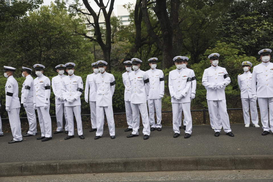 Service members stand on a street on the day of the state funeral for slain former Prime Minister Shinzo Abe, Tuesday, Sept. 27, 2022, in Tokyo. (Leah Millis/Pool Photo via AP)