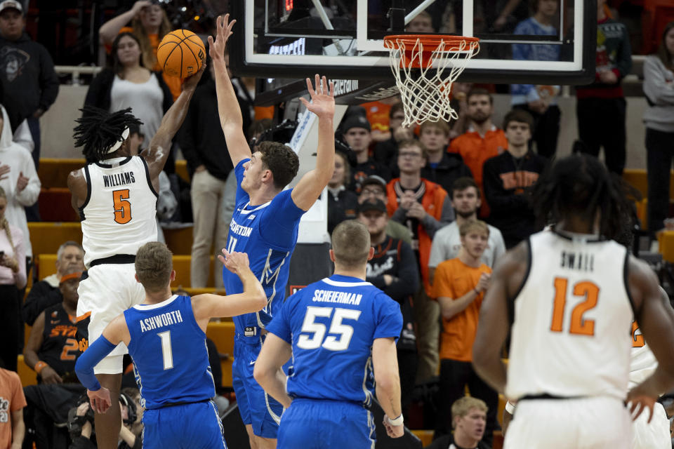 Creighton center Ryan Kalkbrenner blocks Oklahoma State guard Quion Williams' (5) shot in the first half of an NCAA college basketball game, Thursday, Nov. 30, 2023, in Stillwater, Okla. (AP Photo/Mitch Alcala)