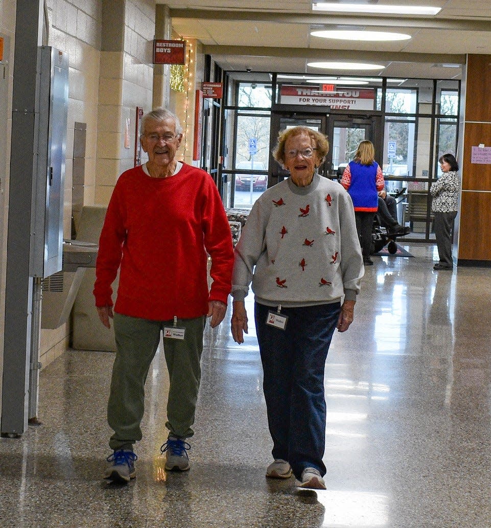 In the summer, Dick and Rosella Stein mow their lawn and tend their many flowerbeds to stay active, but in the winter, they join Walking Club at Port Clinton High School. Here, they walk the halls on Dec. 15.