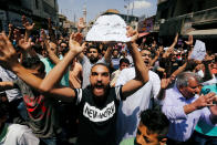 <p>Protesters chant slogans during a protest against the new income tax law and high fuel prices, in Amman, Jordan June 1, 2018. The banner reads in Arabic “we do not have money”. (Photo: Muhammad Hamed/Reuters) </p>