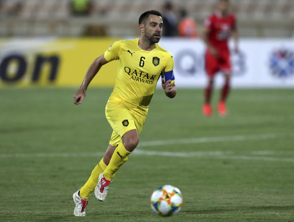 FILE - Qatar's Al-Sadd player Xavi Hernandez, former Barcelona and Spain midfielder, controls the ball during an AFC Champions League match at the Azadi stadium in Tehran, Iran, on May 20, 2019. Cristiano Ronaldo is not the first soccer superstar to head off to one of the world’s supposed minor leagues in the latter years of his career. Many of soccer's biggest names like Pelé, Johan Cruyff, Zico, Xavi Hernandez and now the 37-year-old Ronaldo at Saudi Arabian club Al Nassr have found themselves prolonging their careers at unlikely soccer outposts usually for vast amounts of money. (AP Photo/Vahid Salemi, File)