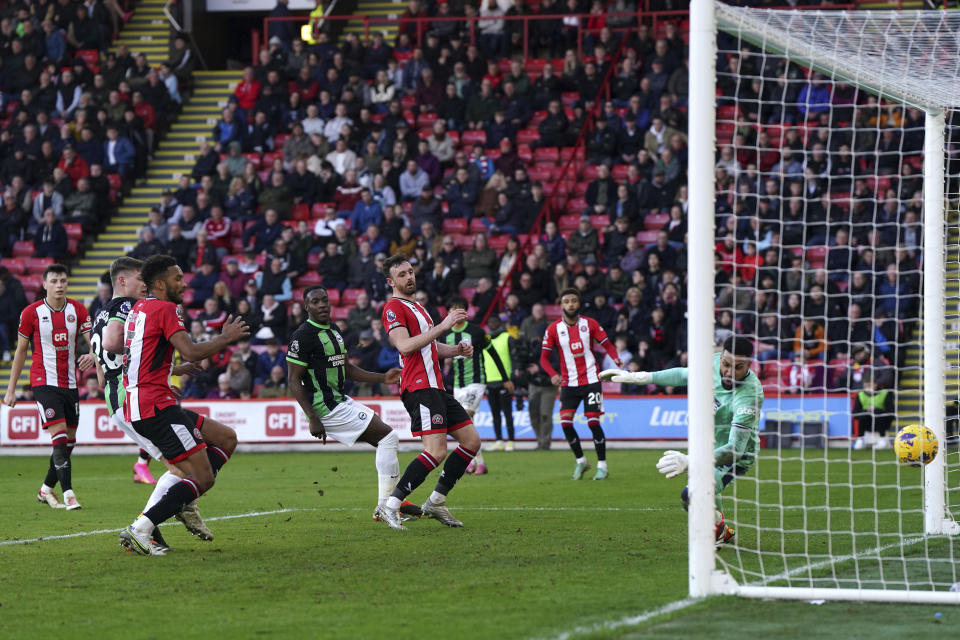 Sheffield United's Jack Robinson scores an own goal, third goal for Brighton's side, during the English Premier League soccer match between Sheffield United and Brighton and Hove Albion at Bramall Lane stadium, Sheffield, England, Sunday, Feb. 18, 2024. (Nick Potts/PA via AP)