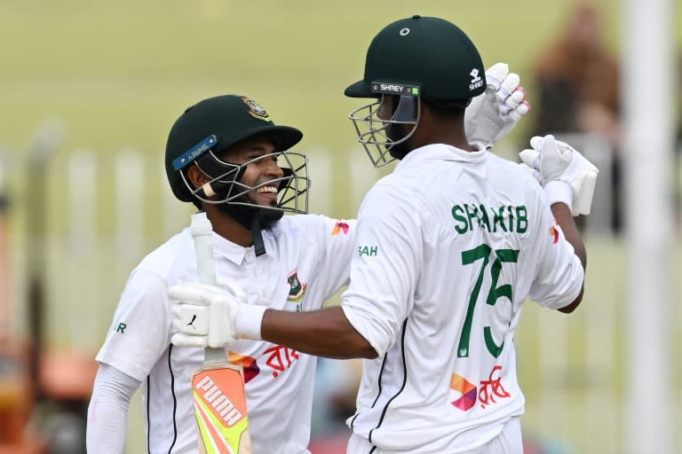 Bangladesh's Mushfiqur Rahim (L) and Shakib Al Hasan celebrate after winning the second Test (Aamir QURESHI)