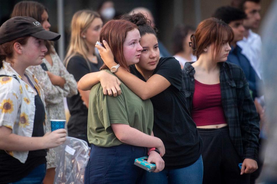Alex Lentz, center, is held by Anahi Castro as they remember the life of Emily Schuett during a vigil held at Colorado Early Colleges at Fort Collins High School on Aug. 18. Emily was killed in an Aug. 10 wreck in Colorado.