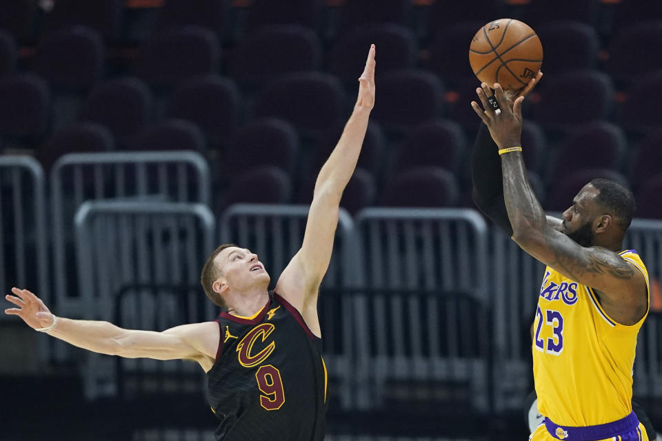 Los Angeles Lakers' LeBron James (23) shoots over Cleveland Cavaliers' Dylan Windler (9) in the first half of an NBA basketball game, Monday, Jan. 25, 2021, in Cleveland. (AP Photo/Tony Dejak)