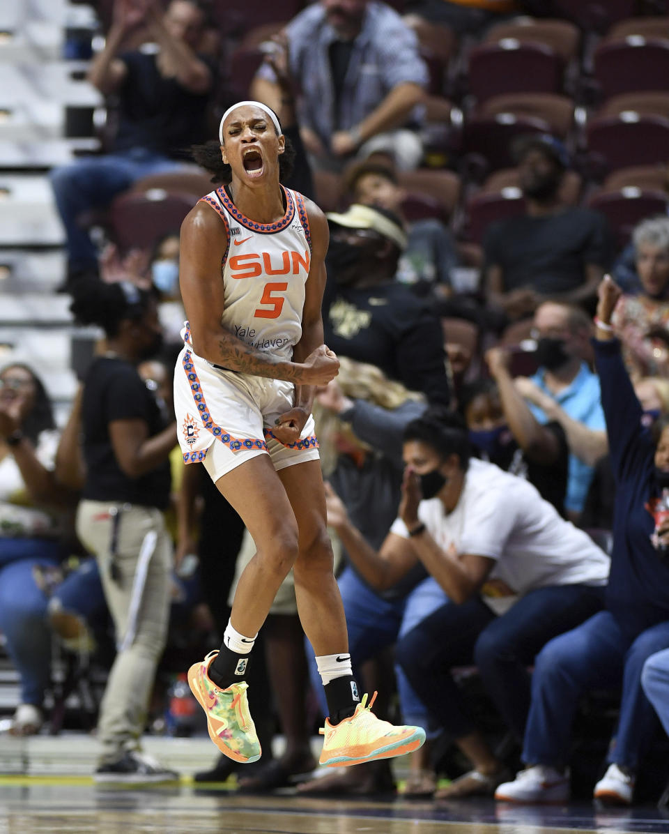 Connecticut Sun guard Jasmine Thomas celebrates a 3-pointer by Briann January against the Los Angeles Sparks during a WNBA basketball game Saturday, Aug. 28, 2021, in Uncasville, Conn. (Sean D. Elliot/The Day via AP)