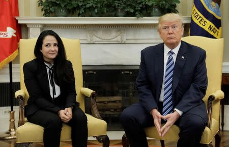 Aya Hijazi, an Egyptian-American woman detained in Egypt for nearly three years on human trafficking charges, meets with U.S. President Donald Trump in the Oval Office of the White House in Washington, U.S., April 21, 2017. REUTERS/Kevin Lamarque