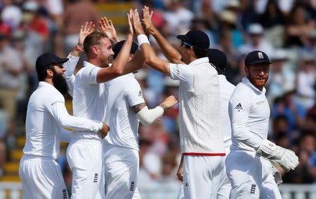 Britain Cricket - England v Pakistan - Third Test - Edgbaston - 7/8/16 England's Stuart Broad celebrates with team mates after taking the wicket of Pakistan's Mohammad Hafeez (not pictured) Action Images via Reuters / Paul Childs