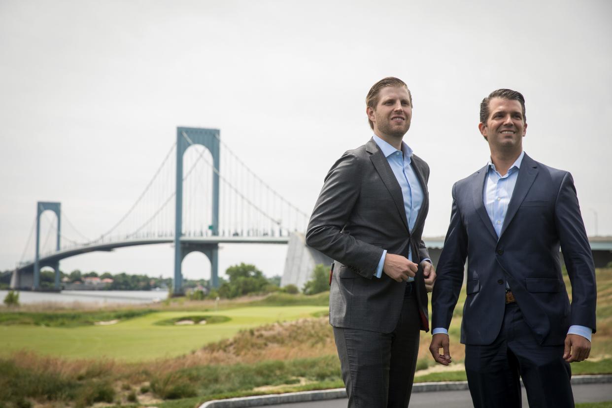 Eric Trump and Donald Trump Jr. pose for photos during a ribbon cutting event for a new clubhouse at Trump Golf Links at Ferry Point, June 11, 2018 in The Bronx borough of New York City.