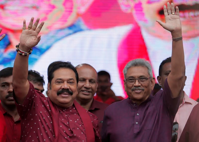 Sri Lanka People's Front party presidential election candidate and former wartime defence chief Rajapaksa and his brother former president and opposition leader Rajapaksa wave at his supporters during an election campaign rally in Ka