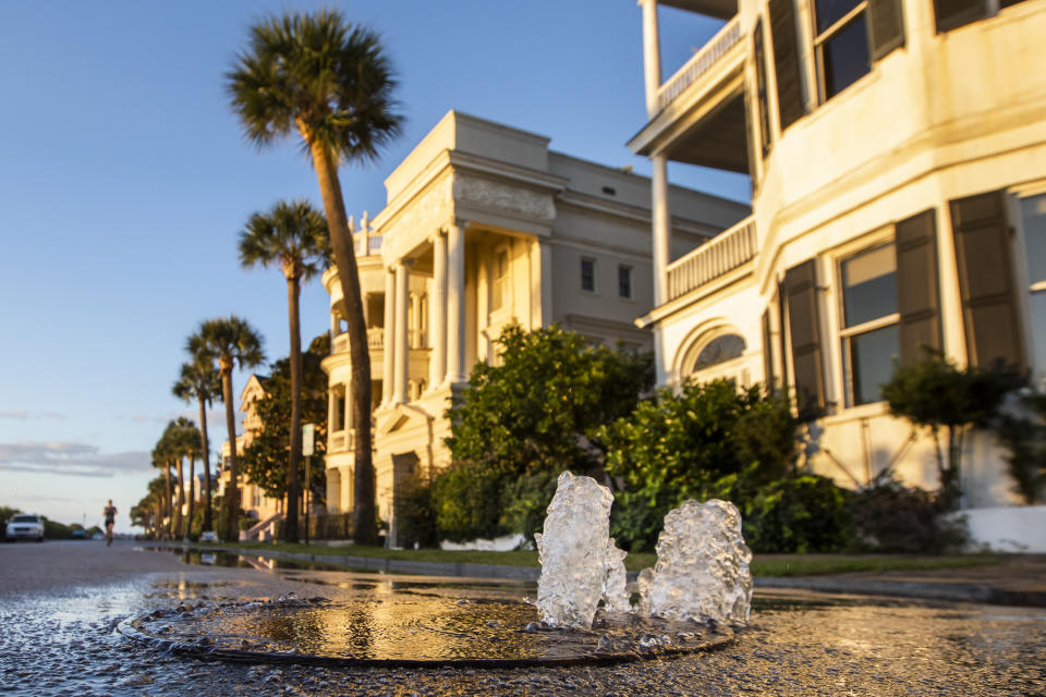 A storm drain bubbles over as a king tide rolls into the Battery in Charleston, S.C. Sunday, Nov. 15, 2020. Charleston has remained relatively unscathed this hurricane season. That means more time to mull a $1.75 billion proposal by the Army Corps of Engineers that features a sea wall along the city's peninsula to protect it from deadly storm surge during hurricanes. (AP Photo/Mic Smith)