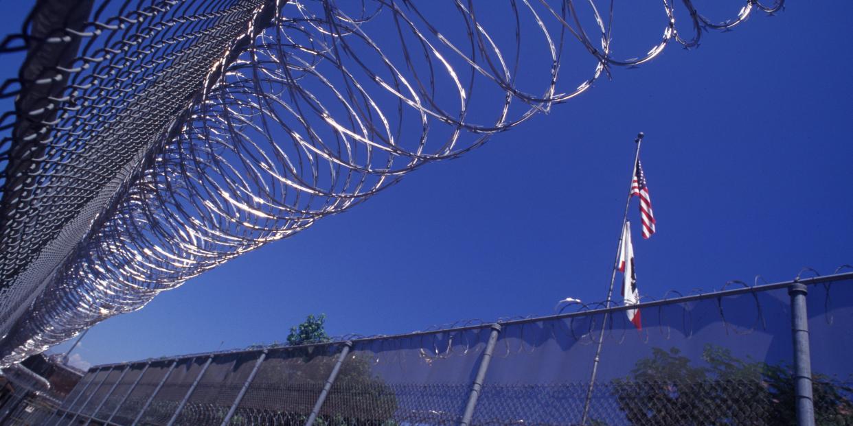 barbed wire and flags at prison