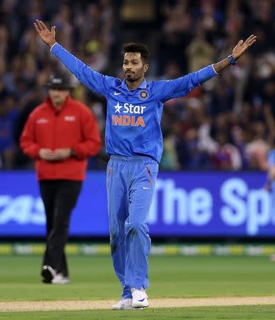 India's Hardik Pandya celebrates after taking the wicket of Australia's Chris Lynn during their T20 cricket match at the Melbourne Cricket Ground, Australia January 29, 2016. REUTERS/Hamish Blair