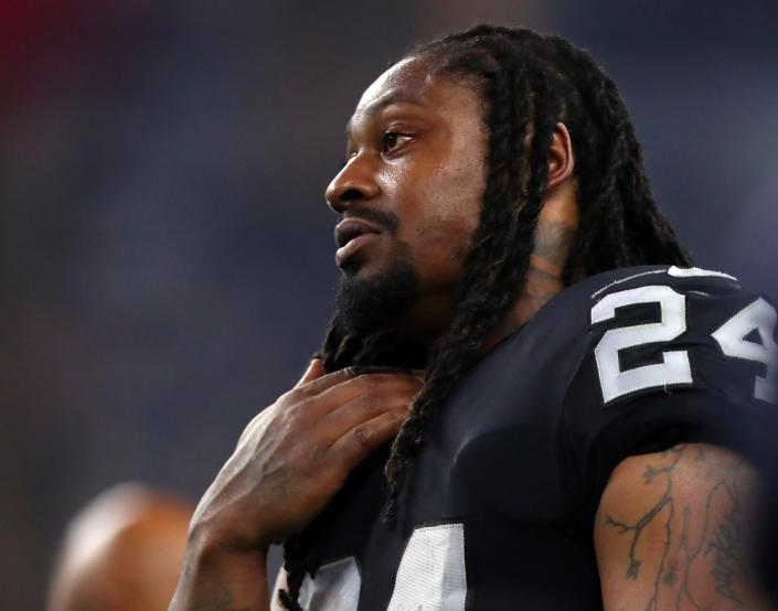 Marshawn Lynch continued his approach of sitting for the national anthem prior to Friday’s game between the Raiders and Lions. (Getty)