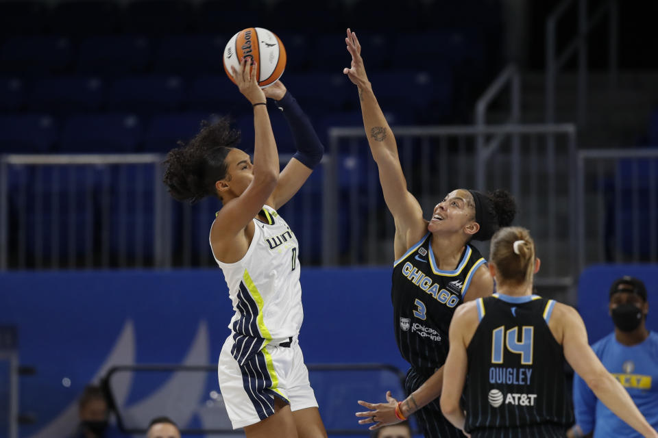 Dallas Wings forward Satou Sabally (0) looks to pass the ball against Chicago Sky center Candace Parker (3) during the first half in the first round of the WNBA basketball playoffs, Thursday, Sept. 23, 2021, in Chicago. (AP Photo/Kamil Krzaczynski)