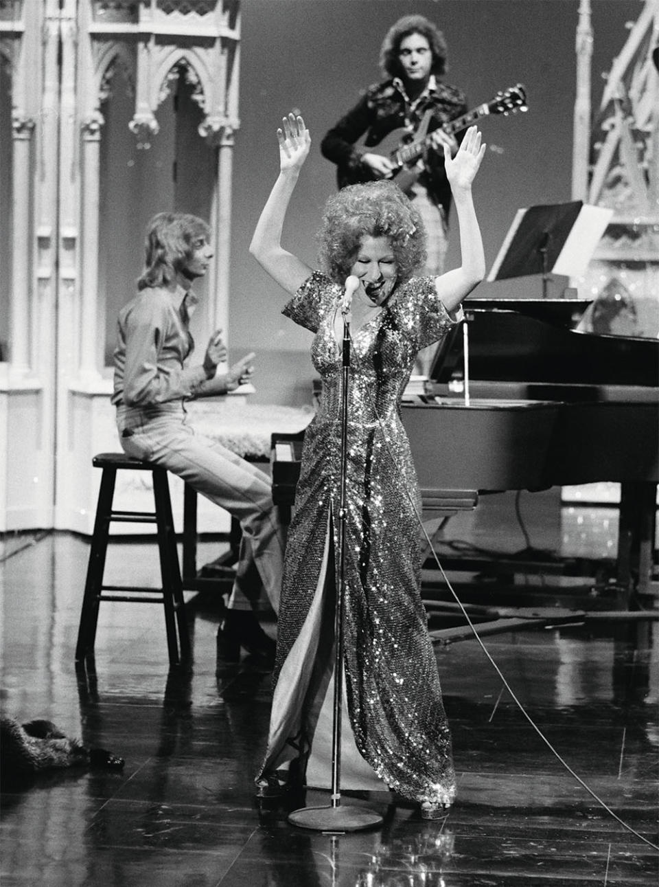 He could make anything funny — or sad. He had a great ear and just so much charm, says Bette Midler, pictured performing with Manilow in September 1973.