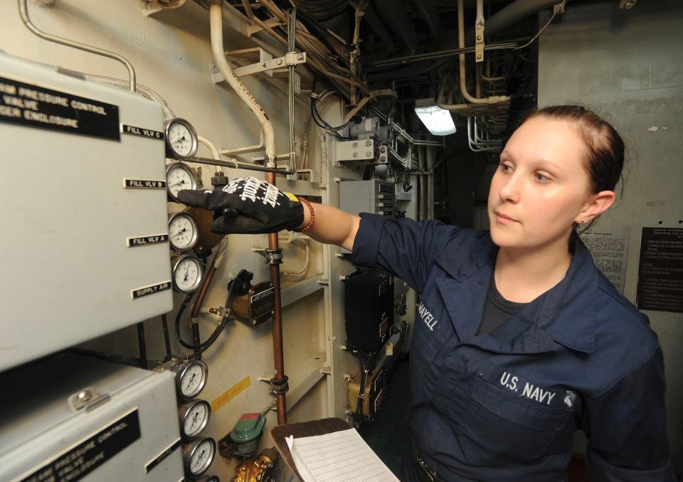 Machinist's Mate Fireman Gopika Mayell checks a steam usage reading in one of the flight deck catapult rooms aboard the aircraft carrier USS George Washington, June 14, 2012.