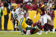 Green Bay Packers wide receiver Amari Rodgers (8) runs with the ball as he avoids Washington Washington Commanders defensive end James Smith-Williams (96) on the last play of an NFL football game Sunday, Oct. 23, 2022, in Landover, Md. (AP Photo/Patrick Semansky)