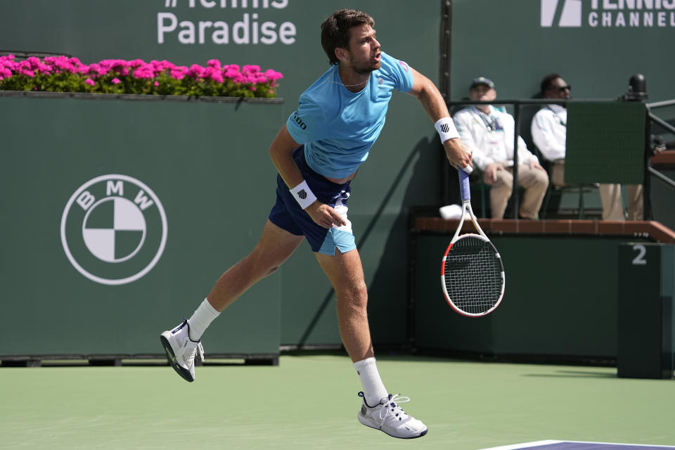 Cameron Norrie, of Britain, serves to Frances Tiafoe, of the United States, at the BNP Paribas Open tennis tournament Wednesday, March 15, 2023, in Indian Wells, Calif. (AP Photo/Mark J. Terrill)