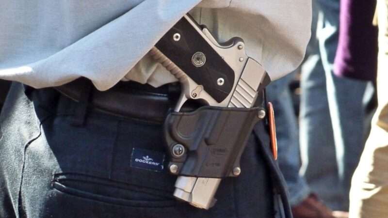 A handgun in a belt holster