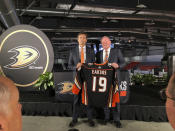 Anaheim Ducks head coach Dallas Eakins, left, and general manager Bob Murray pose with a jersey at Great Park Ice in Irvine, Calif., Monday, June 17, 2019. Eakins was hired as the Ducks' head coach on Monday, moving up from their AHL affiliate to take over a longtime NHL power that stumbled last season. (AP Photo/Greg Beacham)