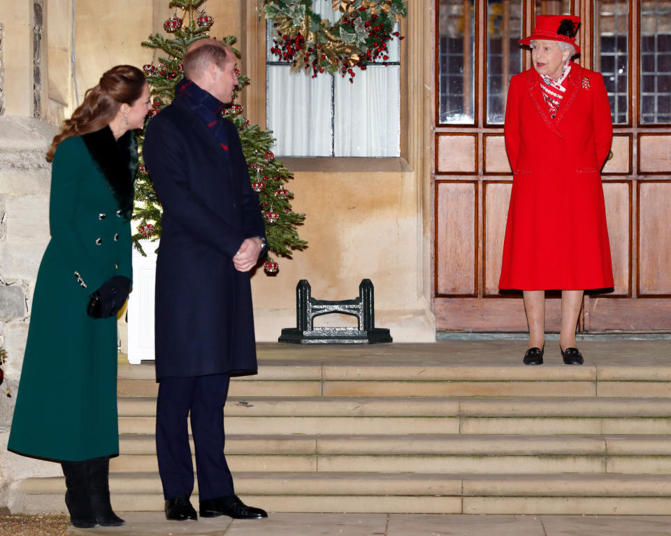 WINDSOR, UNITED KINGDOM - DECEMBER 08: (EMBARGOED FOR PUBLICATION IN UK NEWSPAPERS UNTIL 24 HOURS AFTER CREATE DATE AND TIME) Catherine, Duchess of Cambridge, Prince William, Duke of Cambridge and Queen Elizabeth II attend an event to thank local volunteers and key workers from organisations and charities in Berkshire, who will be volunteering or working to help others over the Christmas period in the quadrangle of Windsor Castle on December 8, 2020 in Windsor, England. During the event members of the Royal Family also listened to Christmas carols performed by The Salvation Army Band. (Photo by Max Mumby/Indigo - Pool/Getty Images)