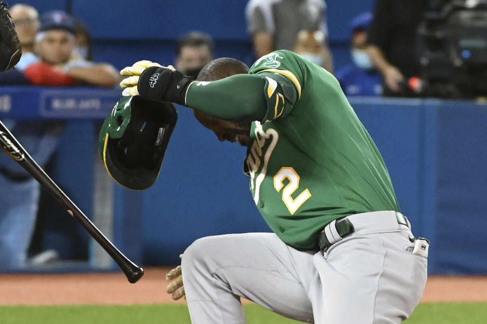 Oakland Athletics' Starling Marte reacts after getting hit on the helmet by a pitch thrown by Toronto Blue Jays' Alek Manoah during the fifth inning of a baseball game Friday, Sept. 3, 2021, in Toronto. (Jon Blacker/The Canadian Press via AP