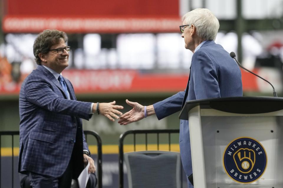 Milwaukee Brewers owner Mark Attanasio and Wisconsin Gov. Tony Evers shake hands before Evers signed Assembly Bill 438 and Assembly Bill 439 at American Family Field Tuesday, Dec. 5, 2023, in Milwaukee. The bills use public funds to help the Milwaukee Brewers repair their stadium over the next three decades. (AP Photo/Morry Gash)