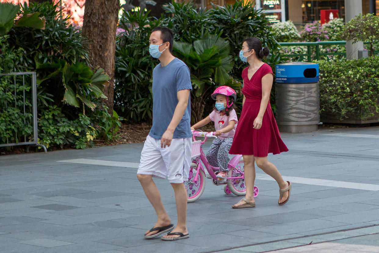 A family wearing face masks seen along Orchard Road on 12 May 2020. (PHOTO: Dhany Osman / Yahoo News Singapore)