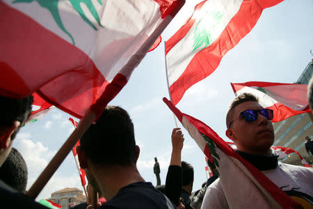 Protesters wave Lebanese national flags during a demonstration against proposed tax increase, in front of the government palace in Beirut, Lebanon March 19, 2017. REUTERS/Alia Haju