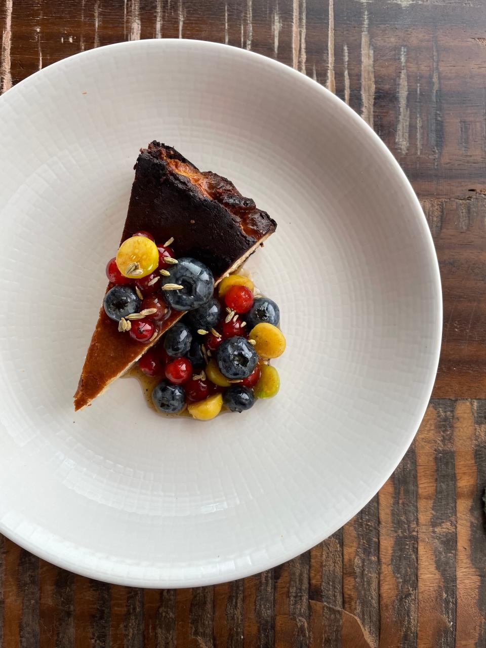 Honey Road and Grey Jay pastry chef Amanda Wildermuth prioritizes local produce in her dessert creations. Pictures is a basque cheesecake with local summer fruit in vermouth caramel. Blueberries are from Adam's Berry Farm, currants are from Last Resort Farm, and husk cherries from Farmer Hill.