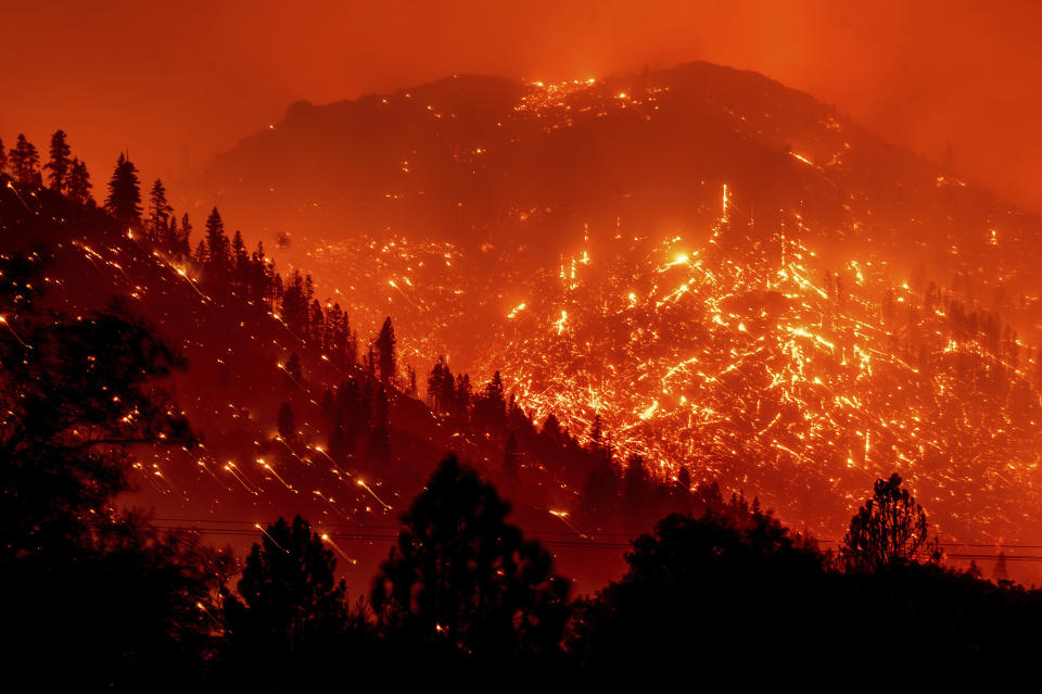 FILE - In this Aug. 17, 2021, file photo, embers light up hillsides as the Dixie Fire burns near Milford in Lassen County, Calif. World leaders have been trying to do something about climate change for 29 years but in that time Earth has gotten much hotter and more dangerous. (AP Photo/Noah Berger, File)