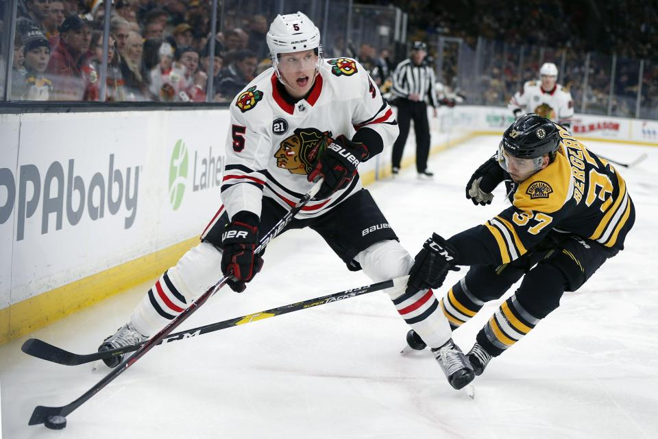 <p>
              Boston Bruins' Patrice Bergeron (37) battles Chicago Blackhawks' Connor Murphy (5) for the puck during the first period of an NHL hockey game in Boston, Tuesday, Feb. 12, 2019. (AP Photo/Michael Dwyer)
            </p>