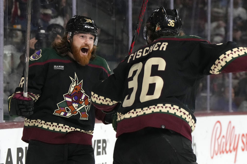 Arizona Coyotes center Liam O'Brien celebrates with right wing Christian Fischer (36) after scoring a goal against the Vancouver Canucks during the first period of an NHL hockey game Thursday, April 13, 2023, in Tempe, Ariz. (AP Photo/Rick Scuteri)