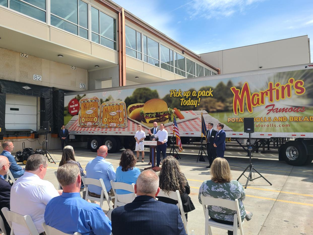 The building housing a new production line could be seen in the background as Gov. Josh Shapiro spoke at Martin's Famous Pastry Shoppe, Chambersburg, on Tuesday, April 30, 2024.