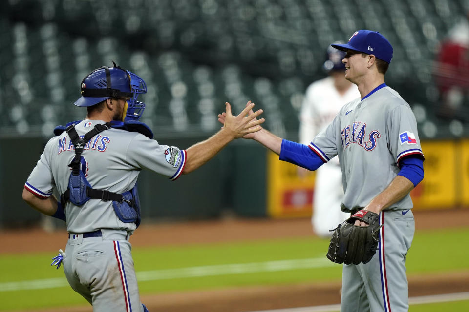 Texas Rangers starting pitcher Kyle Gibson, right, celebrates with catcher Jeff Mathis after a baseball game against the Houston Astros Wednesday, Sept. 16, 2020, in Houston. The Rangers won 1-0. (AP Photo/David J. Phillip)